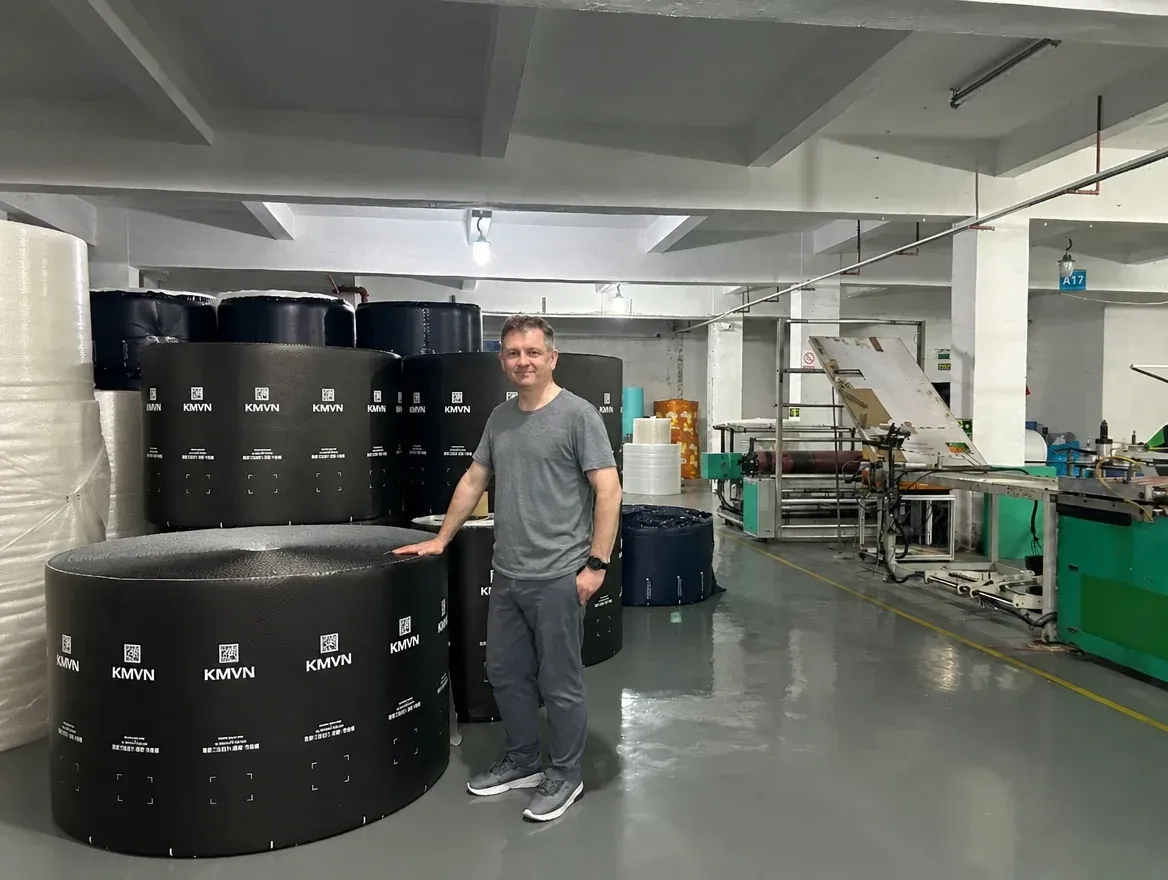 Noel Murphy with finished rolls ready to ship at a packaging factory in China